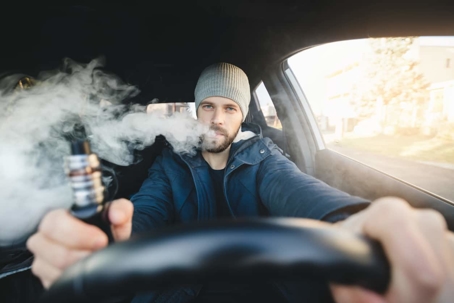 Man vaping in car