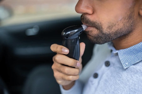 Man blowing in breathalyzer