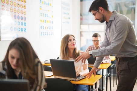 Man talking to woman at desk