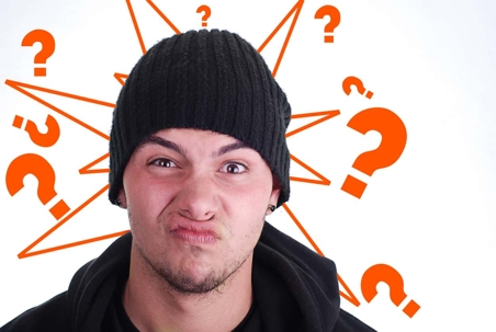 Person surrounded by question marks