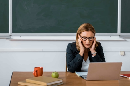 Woman sitting at desk looking at computer